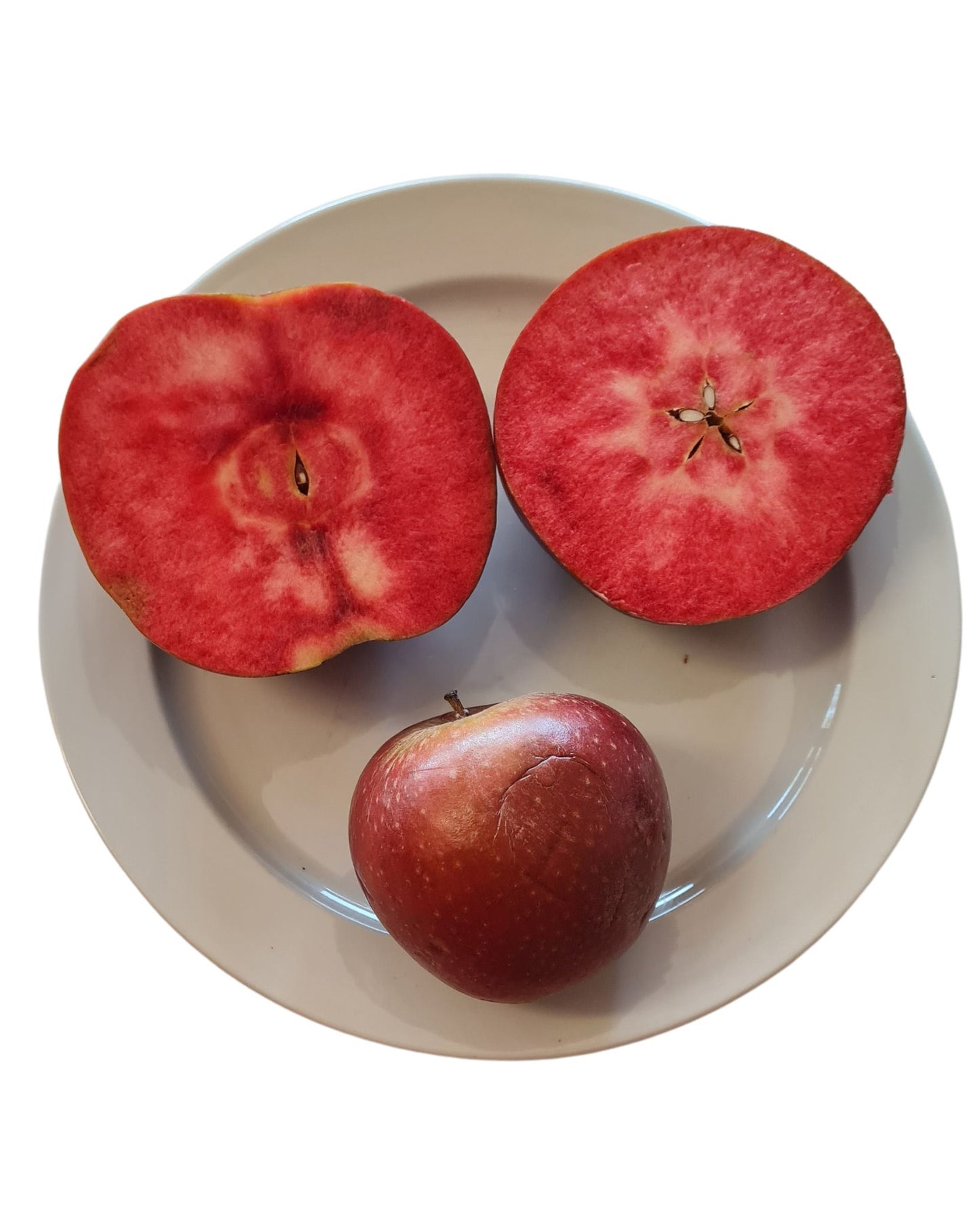 3 Red Fleshed apples on a plate. The apples are red from the core to the skin