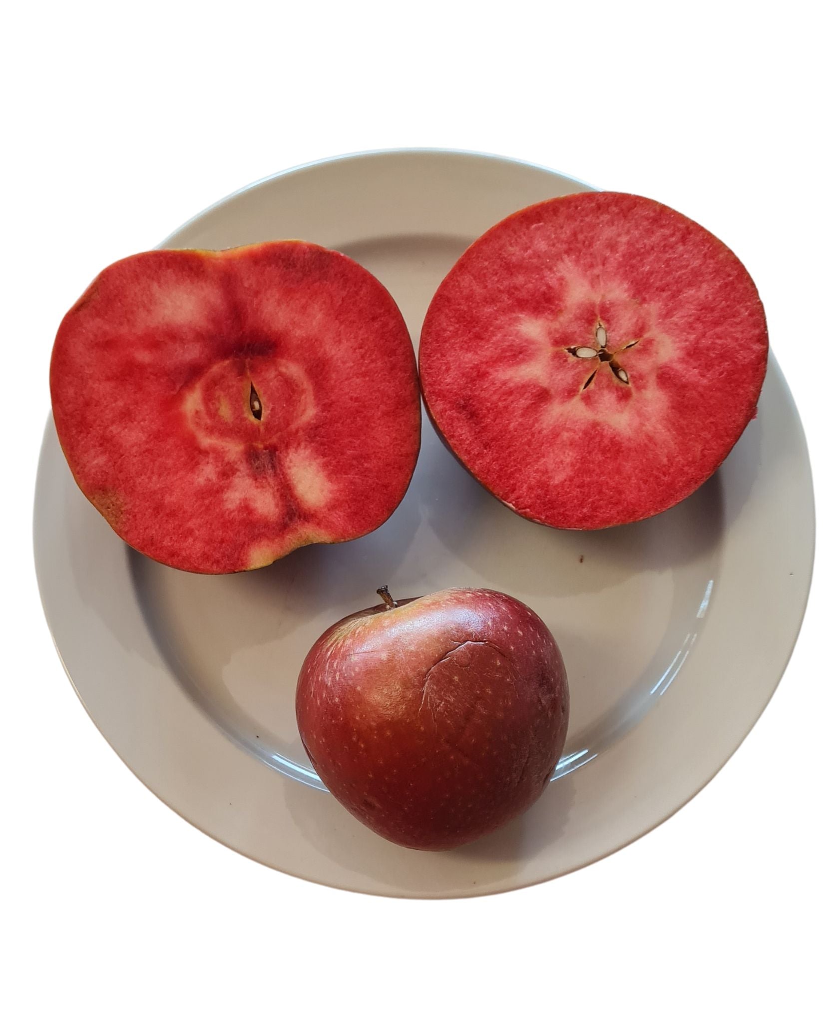 3 Red Fleshed apples on a plate. The apples are red from the core to the skin