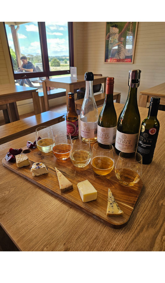 a selection of cheeses and ciders for a perfect cider match