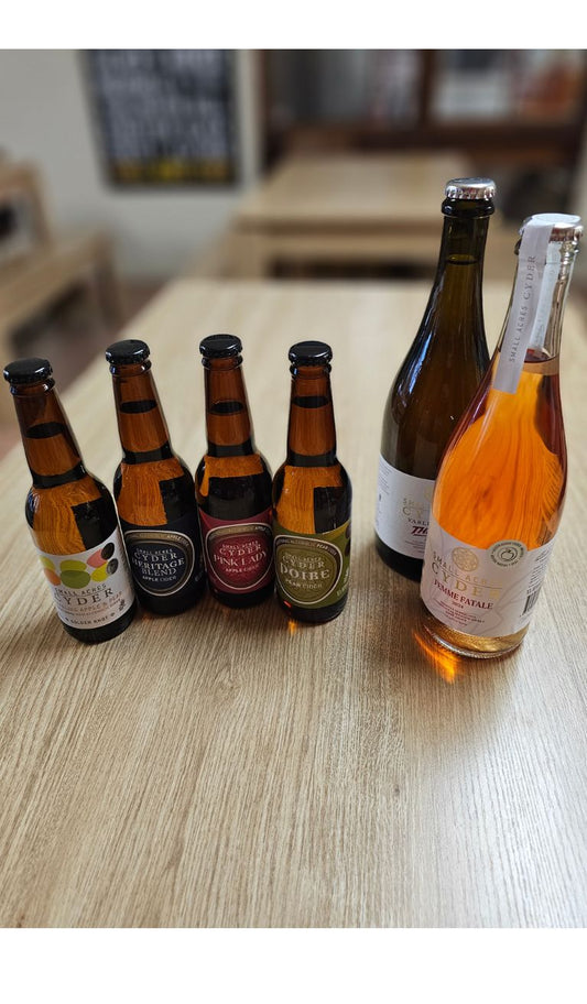 A collection of cider bottles that are part of the Classic Cider Tasting including the Non Alcoholic Apple and Pear, Heritage Blend, Pink Lady and Poire. Two vintage ciders: Yarlington Thrills and Femme Fatale are also featured as choices in the tasting